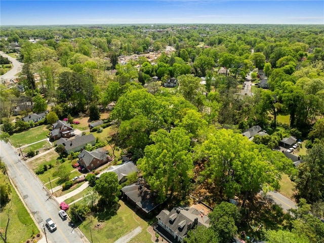 birds eye view of property featuring a wooded view