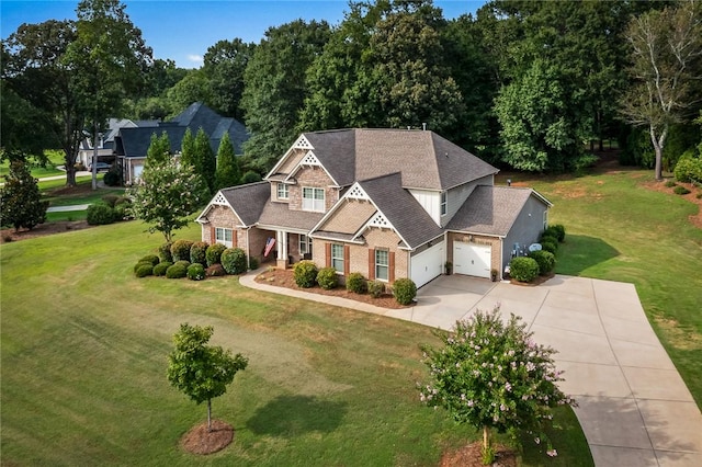 view of front facade with a garage, concrete driveway, brick siding, a front lawn, and roof with shingles