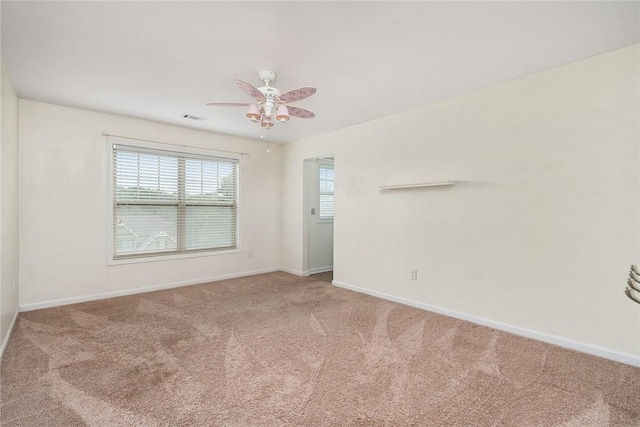 unfurnished room featuring carpet flooring, visible vents, and baseboards