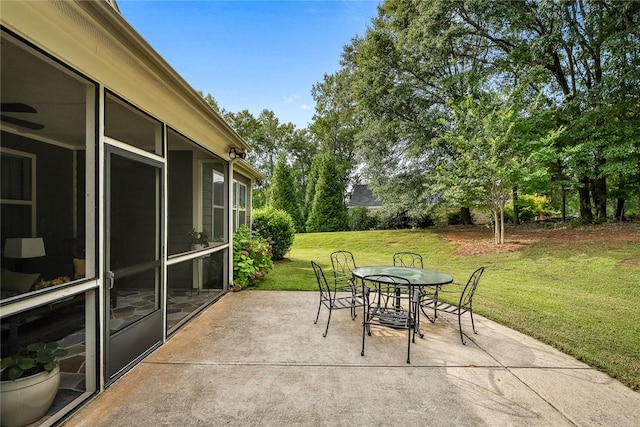 view of patio / terrace featuring outdoor dining area and a sunroom
