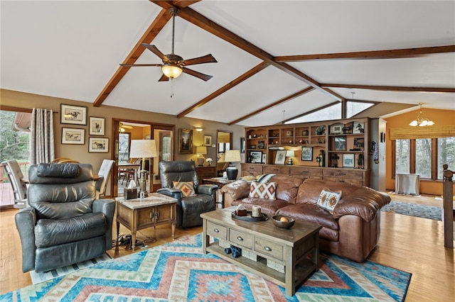 living area with wood finished floors, ceiling fan with notable chandelier, vaulted ceiling with beams, and plenty of natural light