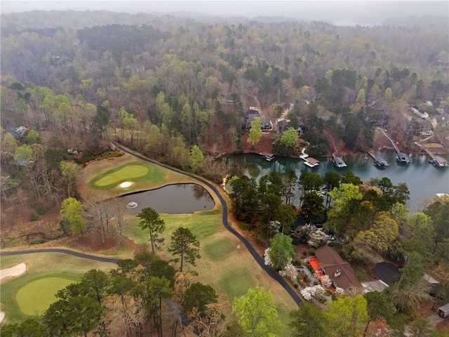 bird's eye view with a view of trees, view of golf course, and a water view