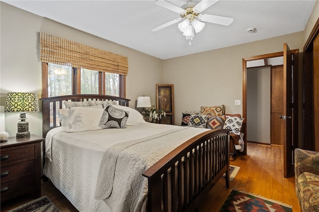 bedroom with ceiling fan and dark wood-type flooring