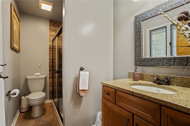 full bathroom with vanity, a shower stall, and toilet