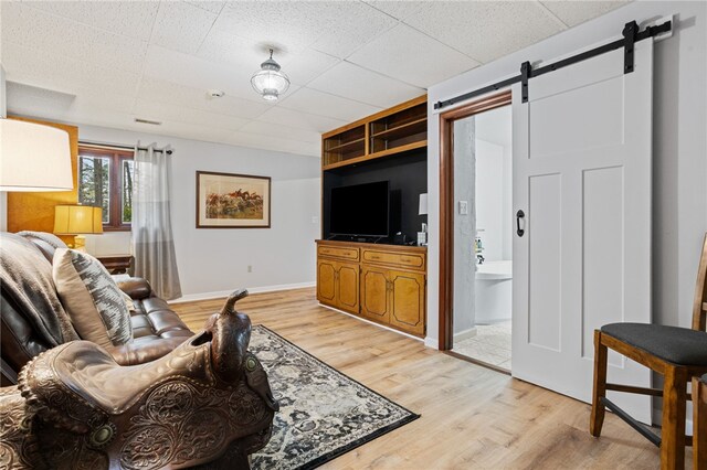 3 Windward Ct, Salem, SC 29676 - living room featuring light wood-style floors, a barn door, baseboards, and a drop ceiling
