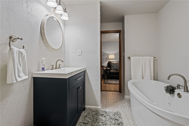 ensuite bathroom with vanity, ensuite bath, a tub to relax in, and tile patterned flooring