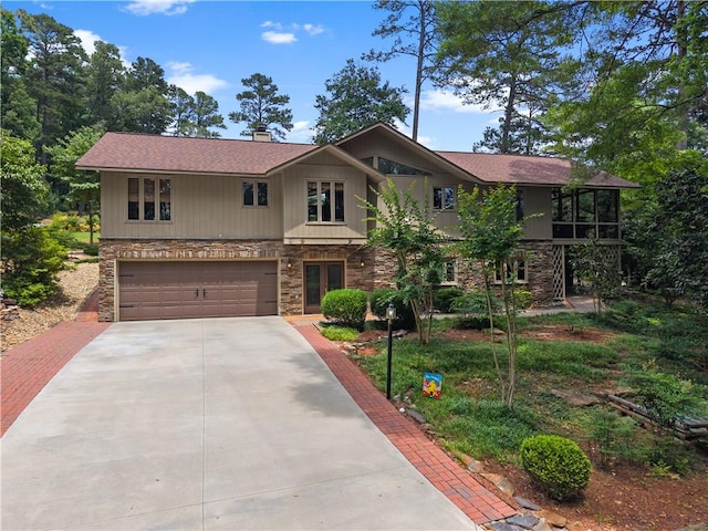 3 Windward Ct, Salem, SC 29676 - view of front of house featuring stone siding, driveway, an attached garage, a sunroom, and roof with shingles