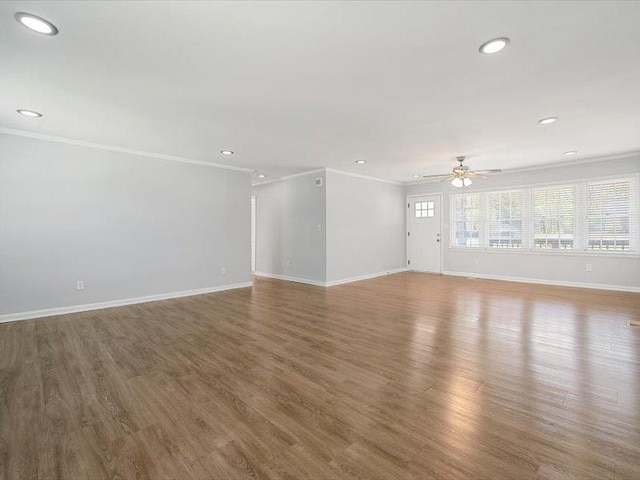 unfurnished living room featuring crown molding, recessed lighting, a ceiling fan, and baseboards