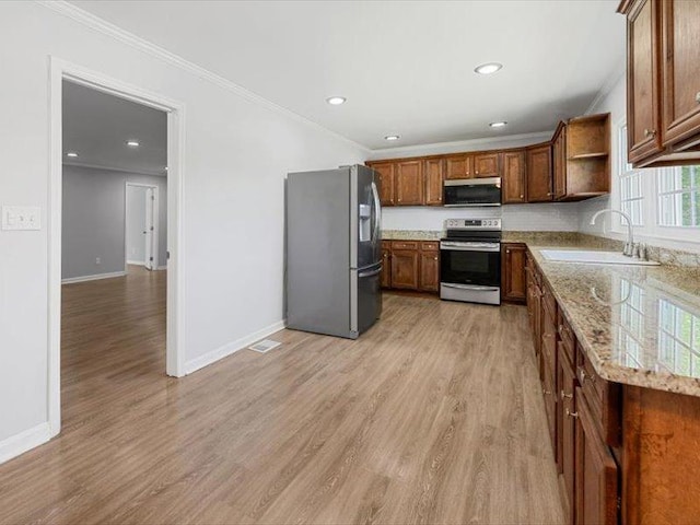 kitchen with open shelves, crown molding, a sink, stainless steel appliances, and light wood finished floors