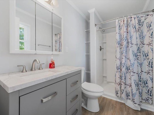 bathroom featuring wood finished floors, a shower stall, toilet, and crown molding