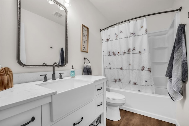 bathroom with shower / bathtub combination with curtain, vanity, visible vents, toilet, and wood finished floors