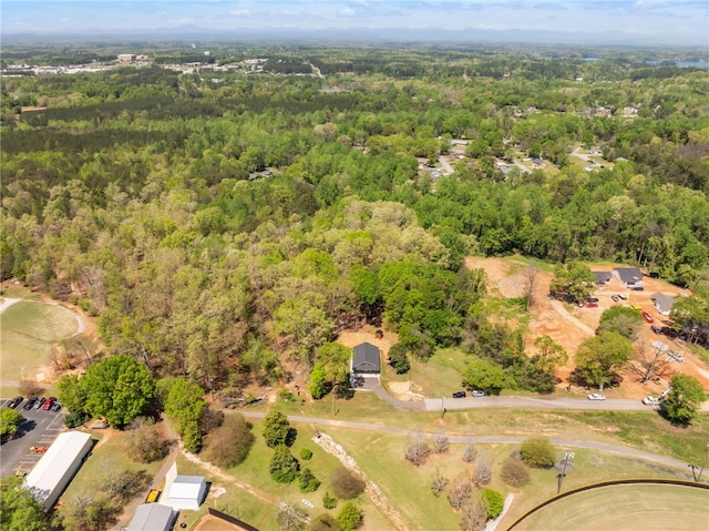 drone / aerial view with a wooded view