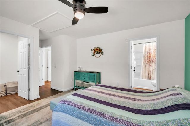 bedroom featuring ceiling fan, attic access, wood finished floors, and baseboards