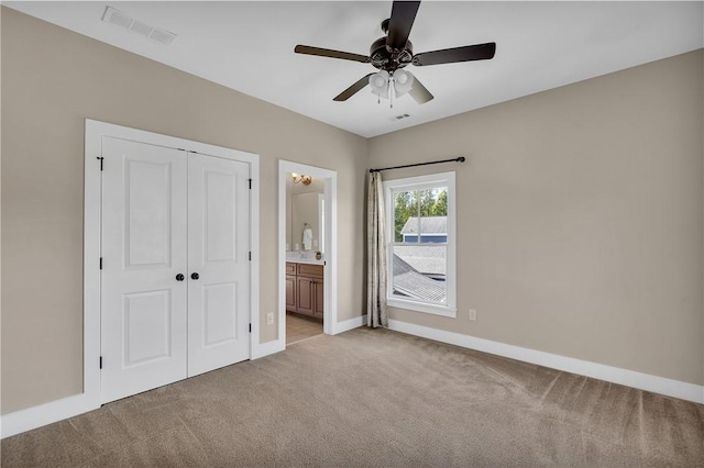 unfurnished bedroom with a closet, visible vents, baseboards, and light carpet