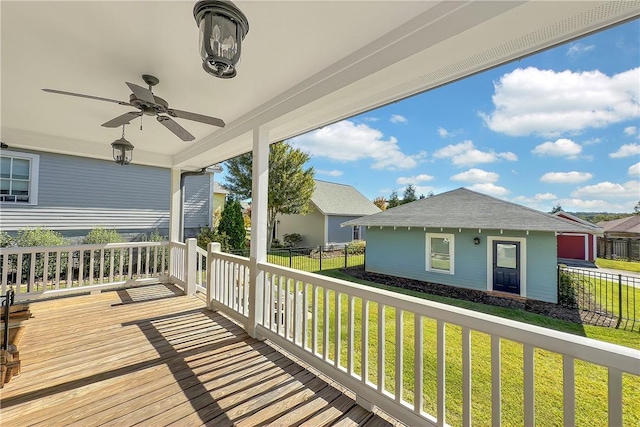 deck with fence, a yard, and ceiling fan