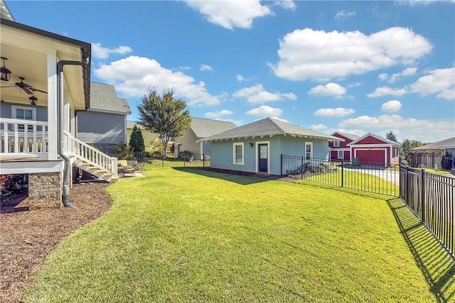 view of yard featuring a garage, stairway, a fenced backyard, and concrete driveway