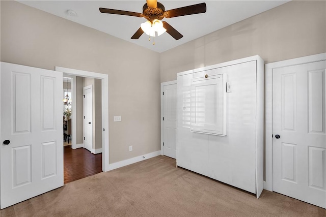 unfurnished bedroom featuring ceiling fan, baseboards, and carpet