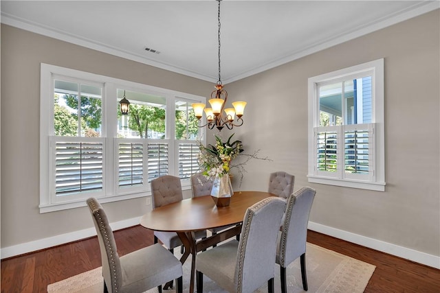 dining room featuring baseboards, visible vents, a chandelier, wood finished floors, and ornamental molding