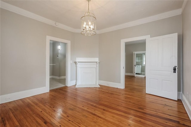 unfurnished dining area with a notable chandelier, baseboards, and hardwood / wood-style floors