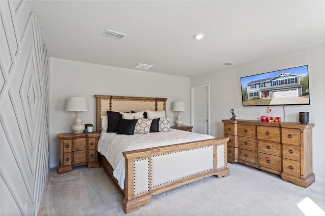 bedroom with light colored carpet, baseboards, and visible vents