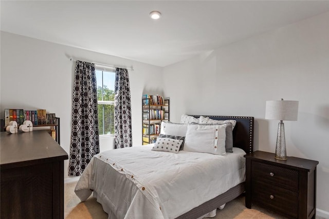 bedroom featuring light carpet