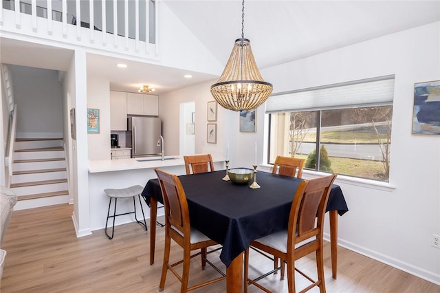 204 Harbor Cove Dr, Salem, SC 29676 - dining room featuring stairway, light wood-style floors, baseboards, and an inviting chandelier