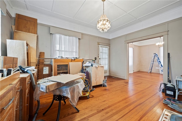 dining room featuring light wood-style floors, a notable chandelier, and ornamental molding