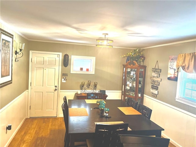 dining area featuring crown molding and wood finished floors