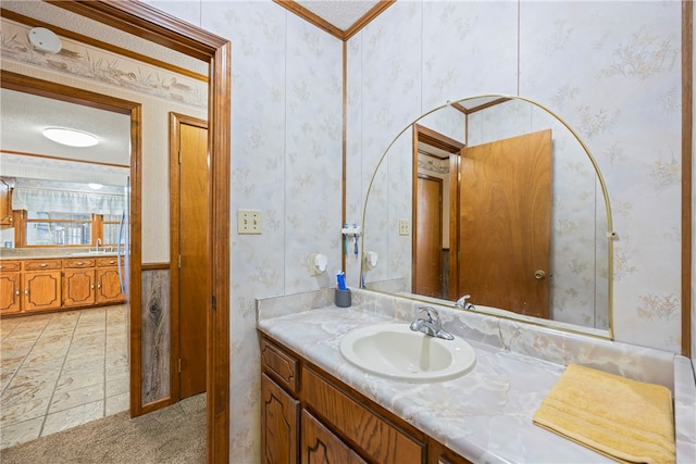 bathroom with wallpapered walls and vanity