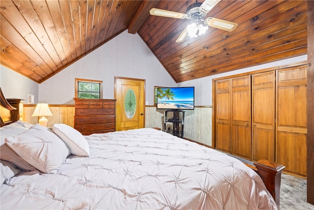 carpeted bedroom featuring wooden ceiling, wood walls, vaulted ceiling with beams, and a wainscoted wall