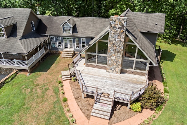 back of property featuring a yard, entry steps, a wooden deck, and a shingled roof