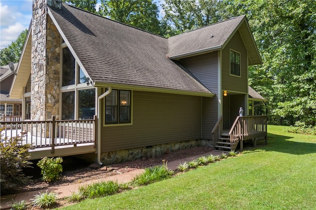 view of side of property with roof with shingles, a chimney, crawl space, a yard, and a deck