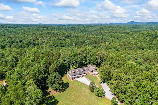 birds eye view of property with a view of trees