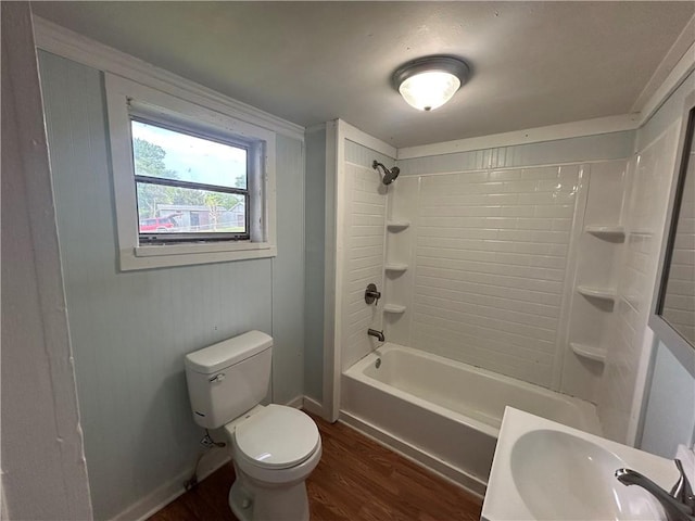 full bathroom featuring baseboards, shower / tub combination, toilet, a sink, and wood finished floors