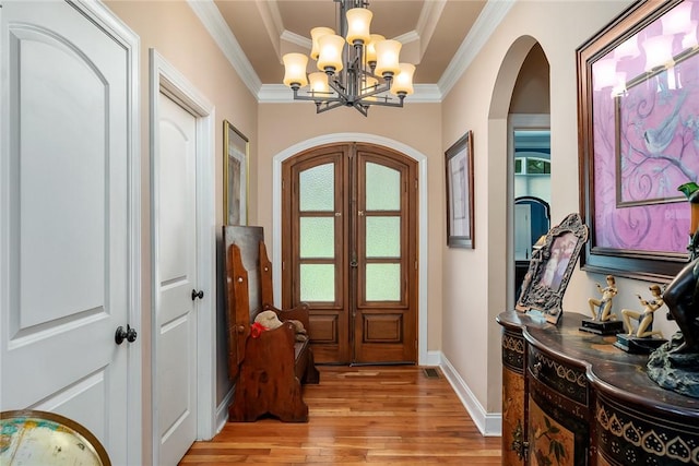 14029 Azalea Dr, Seneca, SC 29678 - entryway with arched walkways, light wood-type flooring, a raised ceiling, a notable chandelier, and baseboards