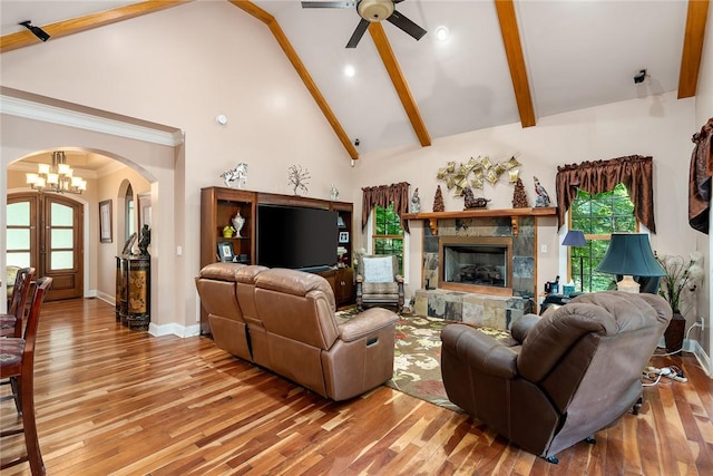 14029 Azalea Dr, Seneca, SC 29678 - living room featuring baseboards, arched walkways, light wood-style floors, beam ceiling, and ceiling fan with notable chandelier