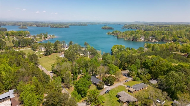 aerial view featuring a forest view and a water view