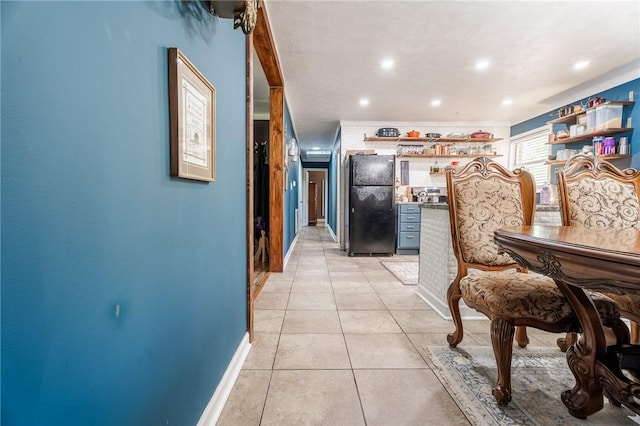 hallway featuring recessed lighting, light tile patterned floors, and baseboards