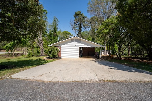 garage featuring concrete driveway