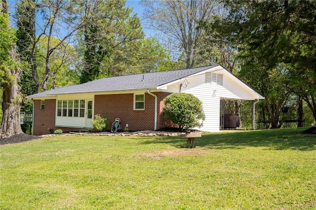 exterior space with a yard and brick siding