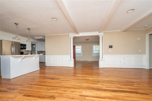204 Clarke Stream Dr, Anderson, SC 29621 - unfurnished living room with decorative columns, a decorative wall, light wood-style floors, and beamed ceiling