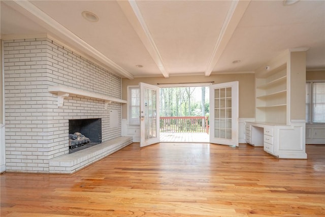 204 Clarke Stream Dr, Anderson, SC 29621 - unfurnished living room featuring a decorative wall, beamed ceiling, ornamental molding, a brick fireplace, and light wood finished floors
