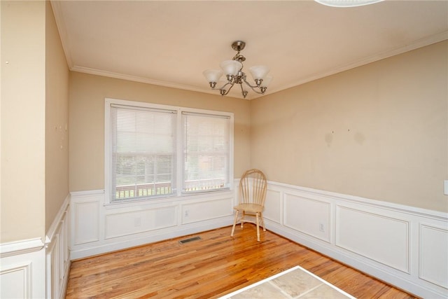 204 Clarke Stream Dr, Anderson, SC 29621 - unfurnished room with visible vents, a notable chandelier, ornamental molding, light wood-style floors, and wainscoting