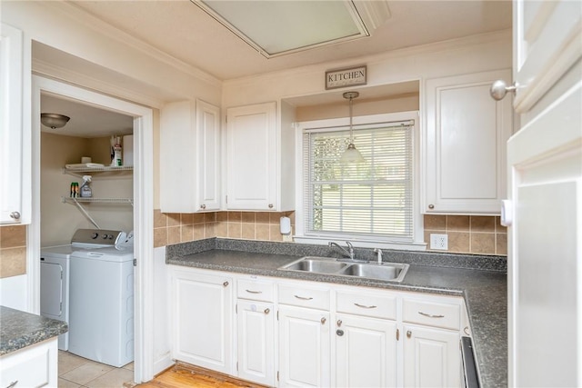 204 Clarke Stream Dr, Anderson, SC 29621 - kitchen with white cabinets, washing machine and clothes dryer, a sink, and dark countertops
