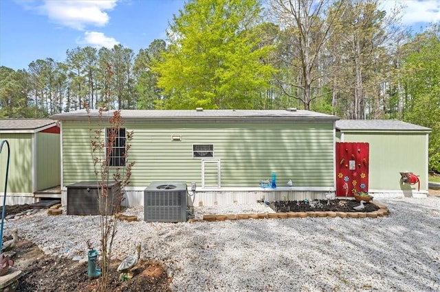 215 Newbury Cir, Westminster, SC 29693 - rear view of property with cooling unit, a shed, and an outbuilding