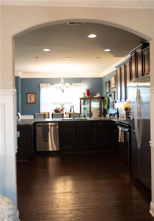 24 Dunsborough Dr, Simpsonville, SC 29680 - kitchen with arched walkways, stainless steel appliances, dark wood-style floors, and a sink