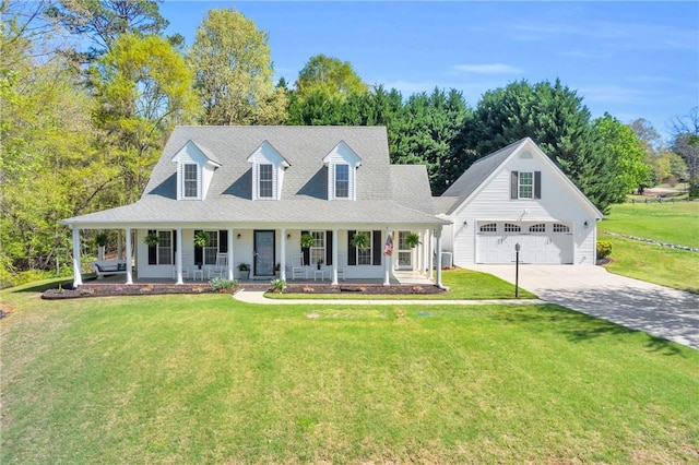 view of front of house with covered porch, a garage, cooling unit, concrete driveway, and a front lawn