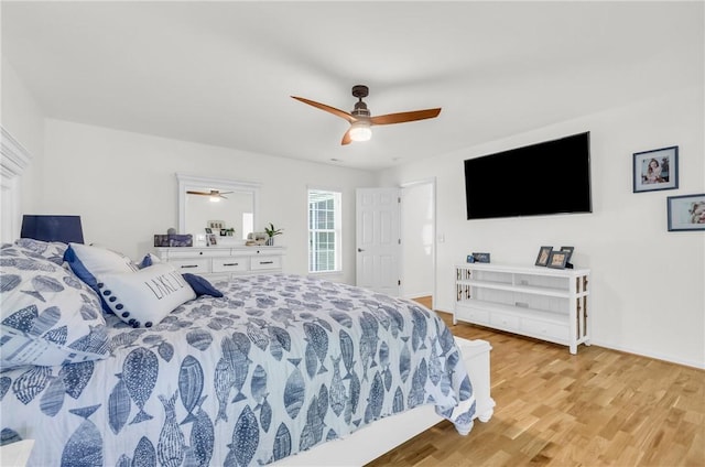bedroom with light wood-style floors and a ceiling fan