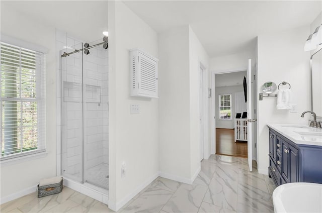 bathroom with a shower stall, vanity, marble finish floor, and baseboards