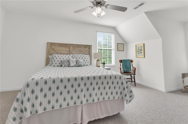 carpeted bedroom featuring visible vents, baseboards, vaulted ceiling, and a ceiling fan